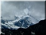 The peak of the Zinal Rothorn emerges from the clouds